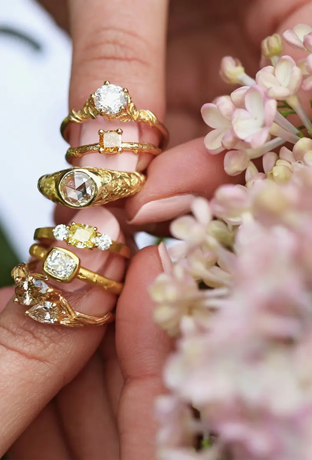 Alex Monroe rings held beside flowers